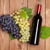 Red wine bottle and bunch of grapes stock photo © karandaev