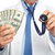 Hands of medical doctor with money. stock photo © Kurhan