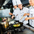 Asian Chefs in restaurant kitchen cooking stock photo © Kzenon