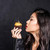 woman holding up halloween cupcake stock photo © LightFieldStudios