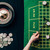 Woman moving chips on casino table with roulette stock photo © LightFieldStudios