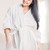 年輕女子 · 浴衣 · 奶油 · 面對 · 年輕 · 微笑的女人 - 商業照片 © LightFieldStudios
