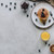 top view of tasty healthy breakfast with pancakes, berries, honey and muesli on grey  stock photo © LightFieldStudios