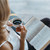 woman reading book and drinking coffee  stock photo © LightFieldStudios