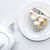 top view of teapot and delicious piece of cake with meringue on white table stock photo © LightFieldStudios