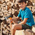 Teenage boy sitting on heap of firewood stock photo © lightkeeper