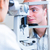 Handsome young man having his eyes examined by an eye doctor stock photo © lightpoet