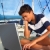 boy teenager seat on boat marina laptop computer stock photo © lunamarina