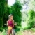 Children girl riding bicycle outdoor in forest smiling stock photo © lunamarina