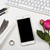 smartphone, computer keyboard and fesh pink flowers on white tab stock photo © manera