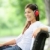 vrouw · luisteren · naar · muziek · park · hoofdtelefoon · glimlachend - stockfoto © Maridav