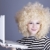 Portrait of funny girl in blonde wig with laptop. stock photo © Massonforstock