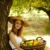 Beautiful redhead girl with fruits in basket at garden. stock photo © Massonforstock
