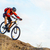 Cyclist in Red Jacket Riding the Bike Down Rocky Hill. Extreme Sport. stock photo © maxpro