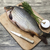 A large fresh carp live fish lying on a wooden board with salt and dill. stock photo © mcherevan