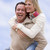 man giving woman piggyback ride outdoors smiling stock photo © monkey_business