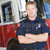 Portrait of a firefighter by a fire engine stock photo © monkey_business