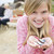 Family at beach with picnic smiling focus on girl with seashells stock photo © monkey_business