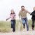Father and two young children running at beach smiling stock photo © monkey_business