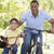 Man and young boy on bikes outdoors smiling stock photo © monkey_business