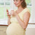 Pregnant woman standing in kitchen with coffee and cigarette smi stock photo © monkey_business