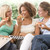 Teenage Girls Sitting On Couch And Eating Pizza Together stock photo © monkey_business