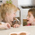Two young boys in kitchen eating cookies smiling stock photo © monkey_business