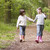 Two sisters walking on path holding hands smiling stock photo © monkey_business