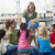 Kindergarten teacher and children looking at globe in library stock photo © monkey_business