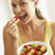 Young Woman Eating A Bowl Of Fruit stock photo © monkey_business