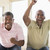 Two men in living room cheering and smiling stock photo © monkey_business