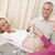 Pregnant woman getting ultrasound from doctor with husband watch stock photo © monkey_business