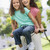 Woman and young girl on a bike outdoors smiling stock photo © monkey_business