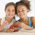 deux · jeunes · filles · manger · fraises · salon - photo stock © monkey_business