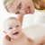 Mother giving baby bubble bath smiling stock photo © monkey_business