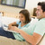 Man with young girl in living room with laptop smiling stock photo © monkey_business