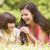 Mother and daughter lying outdoors with flower smiling stock photo © monkey_business