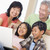 Couple with two young children in living room with laptop smilin stock photo © monkey_business