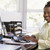 Woman in home office using computer and smiling stock photo © monkey_business