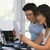 Couple in home office with computer and paperwork smiling stock photo © monkey_business