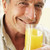 Senior · Mann · lächelnd · Kamera · trinken · Orangensaft - stock foto © monkey_business
