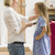Woman in front hallway brushing young girl's hair and smiling stock photo © monkey_business