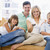 Family sitting in living room with remote control smiling stock photo © monkey_business