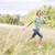 Young girl running in a field smiling stock photo © monkey_business