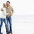 Couple walking on beach arm in arm smiling stock photo © monkey_business