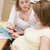 Pregnant woman in kitchen with friend reading pamphlet stock photo © monkey_business
