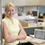 Businesswoman standing in cubicle smiling stock photo © monkey_business