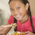 Young girl in dining room eating chinese food smiling stock photo © monkey_business