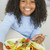 年輕的女孩 · 廚房 · 吃 · 沙拉 · 微笑 · 女孩 - 商業照片 © monkey_business