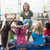 Kindergarten teacher and children with hands raised in library stock photo © monkey_business